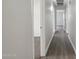 Long hallway with hardwood floors and open doorways at 325 W Angus Rd, San Tan Valley, AZ 85143