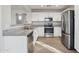 Bright kitchen featuring stainless steel appliances, granite countertops and white cabinetry at 325 W Angus Rd, San Tan Valley, AZ 85143