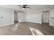 Bright living room with hard surface floors, ceiling fan, and sliding door to another room at 325 W Angus Rd, San Tan Valley, AZ 85143