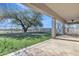A lovely backyard with artificial grass, a covered patio with stone floors, and a black metal fence at 3419 E Rosa Ln, Gilbert, AZ 85297