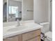 Bathroom featuring a white sink, wood cabinets, and light walls creating a clean and functional space at 3419 E Rosa Ln, Gilbert, AZ 85297
