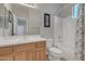 Bathroom features wood cabinets, a framed mirror, and a tub with shower head at 3419 E Rosa Ln, Gilbert, AZ 85297