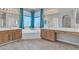 Bright bathroom boasts wood cabinets, tile floors, and a large soaking tub at 3419 E Rosa Ln, Gilbert, AZ 85297