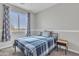 This bedroom features a large window with gray curtains, carpeted floor, and a well-made bed with matching pillow at 3419 E Rosa Ln, Gilbert, AZ 85297