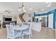 Open-concept floor plan showcasing dining area connected to kitchen and living area, with stairs to upper level at 3419 E Rosa Ln, Gilbert, AZ 85297