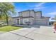 View of home with concrete driveway, gray facade and landscaped front yard under a bright blue sky at 3419 E Rosa Ln, Gilbert, AZ 85297