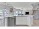 Modern kitchen island with stainless dishwasher, pendant lighting, and open views to the dining and living areas at 3419 E Rosa Ln, Gilbert, AZ 85297