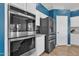Modern kitchen showcasing built in oven, stainless steel refrigerator, granite counters, and white cabinets at 3419 E Rosa Ln, Gilbert, AZ 85297