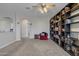 Bright living area with carpet, complemented by custom bookshelves and modern decor for a cozy atmosphere at 3419 E Rosa Ln, Gilbert, AZ 85297