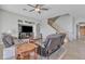 Comfortable living room with a fireplace, staircase, and entertainment center, perfect for relaxation at 3419 E Rosa Ln, Gilbert, AZ 85297