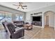 Comfortable living room features plush leather furniture, a ceiling fan, and built-in entertainment center at 3419 E Rosa Ln, Gilbert, AZ 85297