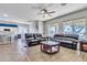 Spacious living room featuring stylish seating, a ceiling fan, and abundant natural light at 3419 E Rosa Ln, Gilbert, AZ 85297