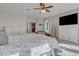 Bright main bedroom features a ceiling fan, plush carpet, and custom dressers at 3419 E Rosa Ln, Gilbert, AZ 85297