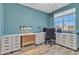 This office has lots of storage in its white cabinets, a computer and a large window with a view at 3419 E Rosa Ln, Gilbert, AZ 85297