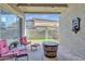 Covered patio featuring stylish chairs, a rustic barrel table, and string lights for cozy outdoor entertaining at 3419 E Rosa Ln, Gilbert, AZ 85297