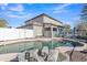 Beautiful backyard pool area with patio furniture, rock features, and a well-maintained home exterior at 3419 E Rosa Ln, Gilbert, AZ 85297