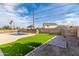 Backyard featuring lush artificial grass, stone patio, and privacy fence, designed for outdoor relaxation at 3939 E Sahuaro Dr, Phoenix, AZ 85028