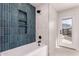 Modern bathroom showcasing a soaking tub, blue vertical tile, and a glass-enclosed shower at 3939 E Sahuaro Dr, Phoenix, AZ 85028