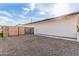 Home featuring gravel driveway, gated access, and light brick exterior, offering curb appeal and functionality at 3939 E Sahuaro Dr, Phoenix, AZ 85028