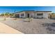 Contemporary home showcasing minimalist xeriscaping with a chic, dark gray garage door and modern design elements at 3939 E Sahuaro Dr, Phoenix, AZ 85028