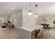 Open-concept kitchen featuring a quartz island, wood cabinets, and an airy design that flows into the dining and living areas at 3939 E Sahuaro Dr, Phoenix, AZ 85028
