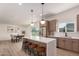 Bright kitchen with a large island, seating, modern appliances, and seamless connection to the dining area at 3939 E Sahuaro Dr, Phoenix, AZ 85028