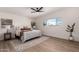 Bright main bedroom with wood floors, ceiling fan, and neutral decor at 3939 E Sahuaro Dr, Phoenix, AZ 85028