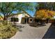 Spacious backyard boasts gravel landscaping, mature trees, and a covered patio, creating a tranquil outdoor retreat at 399 W Buena Vista Dr, Tempe, AZ 85284