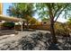 Backyard features a covered patio, gravel landscaping, mature shade trees, and a low-maintenance design at 399 W Buena Vista Dr, Tempe, AZ 85284