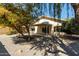 Large backyard features a covered patio, gravel landscaping, and mature trees for shade and privacy at 399 W Buena Vista Dr, Tempe, AZ 85284