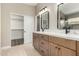 Primary bathroom featuring double sink vanity, large mirrors, and walk-in closet at 399 W Buena Vista Dr, Tempe, AZ 85284