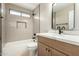 Bathroom featuring modern finishes, white countertops, oak cabinetry, and black hardware at 399 W Buena Vista Dr, Tempe, AZ 85284
