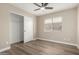 Light-filled bedroom features a ceiling fan, wood-style floor, and closet at 399 W Buena Vista Dr, Tempe, AZ 85284
