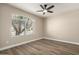 Bright bedroom with ceiling fan and large arched window allowing natural light to fill the room at 399 W Buena Vista Dr, Tempe, AZ 85284
