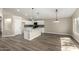 Bright kitchen features a large island with waterfall countertops and modern pendant lighting at 399 W Buena Vista Dr, Tempe, AZ 85284