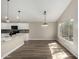 Bright eat-in kitchen with white cabinets, black appliances, and a garden view window at 399 W Buena Vista Dr, Tempe, AZ 85284