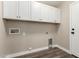 Spacious laundry room with white cabinets, neutral walls, and modern flooring at 399 W Buena Vista Dr, Tempe, AZ 85284