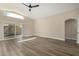Bright living room with wood-look flooring, vaulted ceilings, and sliding glass doors leading to the backyard at 399 W Buena Vista Dr, Tempe, AZ 85284
