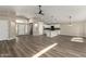 Spacious open-concept living room with wood floors flowing into a modern, white kitchen at 399 W Buena Vista Dr, Tempe, AZ 85284