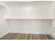 Spacious walk-in closet features wood floor, with custom shelving and closet rod for maximum storage at 399 W Buena Vista Dr, Tempe, AZ 85284