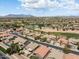 High-angle view of a peaceful neighborhood surrounded by a golf course and scenic desert landscape at 42476 W Chisholm Dr, Maricopa, AZ 85138