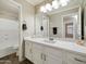 Bathroom featuring a large vanity with double sinks, quartz counters, and a shower/tub combo at 42476 W Chisholm Dr, Maricopa, AZ 85138