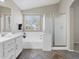 Bathroom with a shower, soaking tub, double sinks, and large mirrors at 42476 W Chisholm Dr, Maricopa, AZ 85138