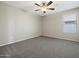 This bedroom offers neutral walls, ceiling fan and carpet flooring, providing a cozy and comfortable space at 42476 W Chisholm Dr, Maricopa, AZ 85138