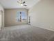 Spacious bedroom with vaulted ceiling, large window and gray carpet at 42476 W Chisholm Dr, Maricopa, AZ 85138