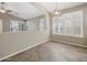 Open-concept dining area with ample natural light and stylish light fixture at 42476 W Chisholm Dr, Maricopa, AZ 85138