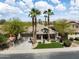 Charming single-Gathering home featuring a well-manicured lawn and mature palm trees in a desirable neighborhood at 42476 W Chisholm Dr, Maricopa, AZ 85138