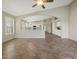Living room with archway to the kitchen features tile floors, and neutral paint at 42476 W Chisholm Dr, Maricopa, AZ 85138