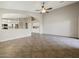 Living room with archway to the kitchen features tile floors, and neutral paint at 42476 W Chisholm Dr, Maricopa, AZ 85138