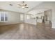 Living room with archway to the kitchen features tile floors, and neutral paint at 42476 W Chisholm Dr, Maricopa, AZ 85138
